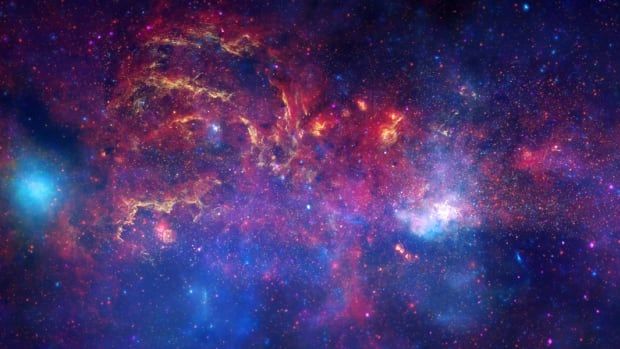 An image of the centre of the Milky Way galaxy, star systems and other space phenomena are rendered in colours of red, purple and blue.