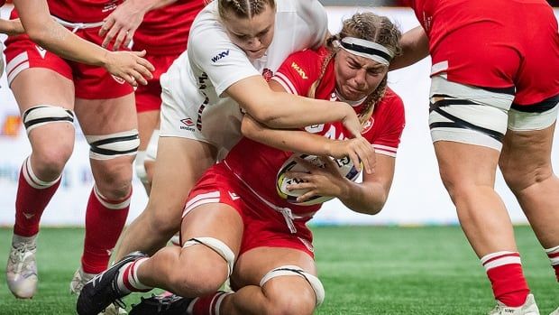 England's Mackenzie Carson tackles Canada's Laetitia Royer during WXV 1 women's rugby union action in Vancouver on Oct. 12, 2024.