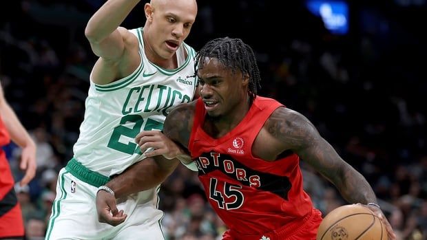 Toronto Raptors guard Davion Mitchell defends the ball from Boston Celtics guard Jordan Walsh during an Oct. 13, 2024 NBA pre-season game in Boston. 