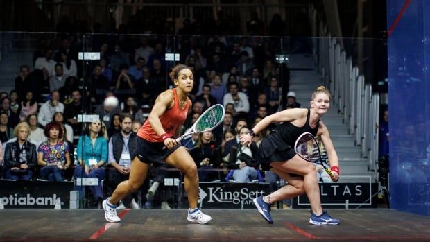 Two women's squash players compete.