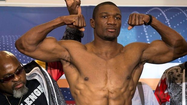 Canadian boxer Troy Ross and his trainer Christopher Amos, left, pose during weigh-in in Bamberg, southern Germany on Sept. 14, 2012. 