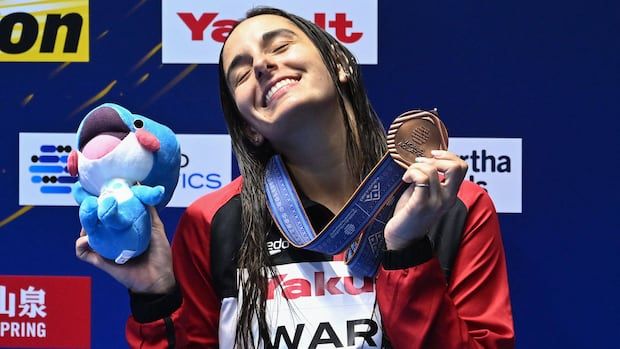 Canadian diver Pamela Ware poses with her world championship bronze medal in Fukuoka, Japan on July 21, 2023.