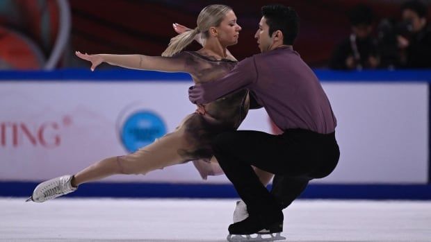 Two ice dancers compete on the ice.