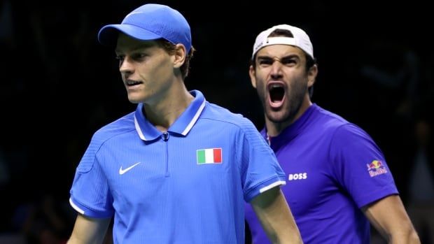 Two men's tennis players celebrate.