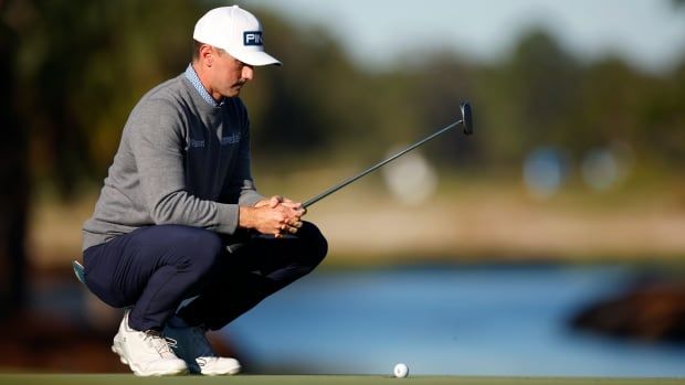 Canadian male golfer lines up a putt on the 18th green during the third round of The RSM Classic 2024 on the Seaside course at Sea Island Resort on November 23, 2024 in St Simons Island, Georgia. (Photo by Mike Ehrmann/Getty Images)