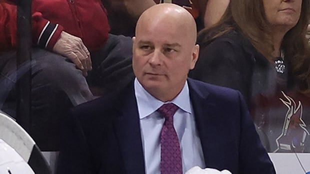 Boston Bruins head coach Jim Montgomery is pictured standing behind the team's bench game at Mullett Arena on Jan. 9, 2024 in Tempe, Arizona. 