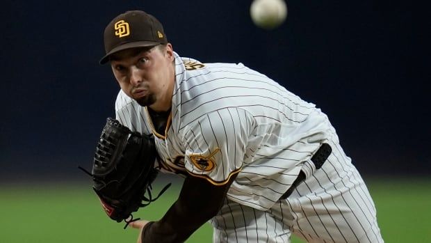 A baseball player throws the ball.