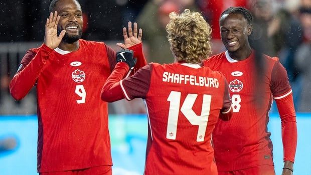 Canada's Jacob Shaffelburg is congratulated by fellow forward Cyle Larin and midfielder Ismaël Koné after sconing his second goal of the game against Suriname in CONCACAF Nations League action in Toronto on Nov. 19, 2024.