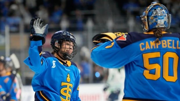 Two Toronto Sceptres female players celebrate a goal.