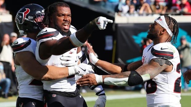 Three male Houston Texans players.