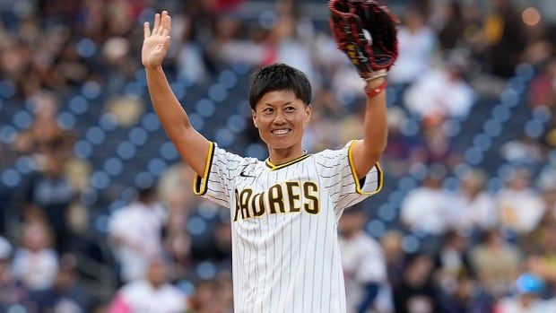 Japanese baseball player Ayami Sato waves to the crowd before throwing out a ceremonial first pitch before the San Diego Padres host the Houston Astros in a MLB regular-season game in California on Sept. 16, 2024.