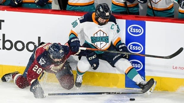 2 women playing hockey