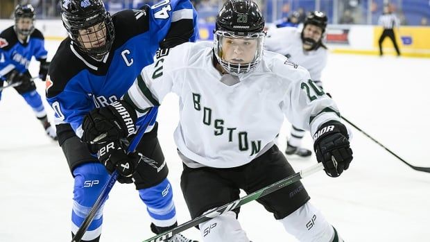 Toronto's Blayre Turnbull and Boston's Hannah Brandt battle for the puck during PWHL regular-season action in Toronto on Jan. 17, 2023.