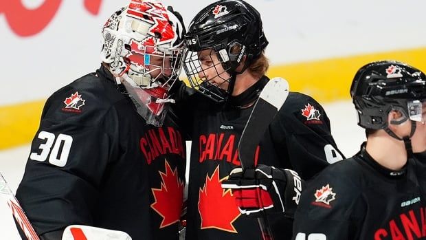 Canadian forward Gavin McKenna and goalie Carter George celebrate a 3-2 win over the Czech Republic in pre-world junior hockey championship action in Ottawa on Dec. 23, 2024.