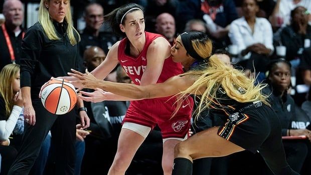 American basketball player Caitlin Clark of the Indiana Fever looks to pass against DiJonai Carrington of the Connecticut Sun during the first quarter of Game 2 of a first-round WNBA playoff series at Mohegan Sun Arena on September 25, 2024 in Uncasville, Connecticut. 