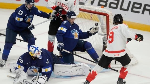 Canada male forward scores on Finland goaltender as defencemen try to cover the net during first period IIHF World Junior Hockey Championship tournament action on Thursday, Dec.26, 2024 in Ottawa. 