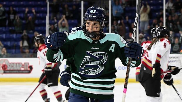 Women's hockey player celebrates goal