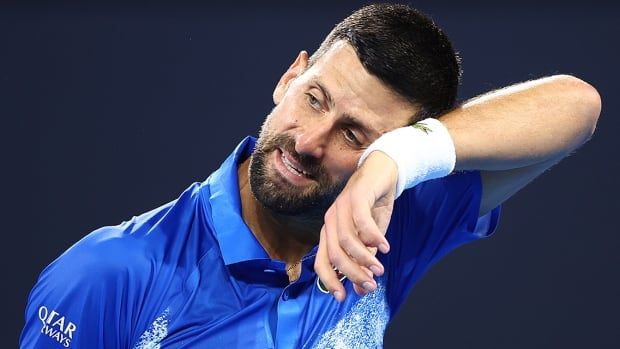 Serbian men's tennis player Novak Djokovic looks on in his quarterfinal match against Reilly Opelka of the United States at the Brisbane International on January 3, 2025 in Australia.