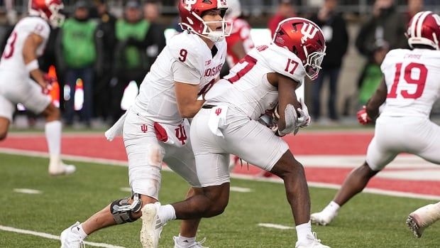 Indiana Hoosiers quarterback Kurtis Rourke of Oakville, Ontario, hands the ball off to running back Ty Son Lawton during an American college football game against the Ohio State Buckeyes on November 23, 2024 in Columbus.