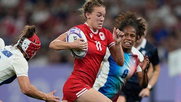 Canadian women's rugby player Piper Logan drives to score a try during sevens quarterfinal play at the Olympics on July 29, 2024 in Saint-Denis, France.