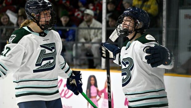 Boston Fleet's Sidney Morin (7) celebrates overtime goal against the Ottawa Charge with Shay Maloney (27).