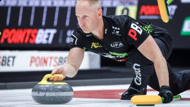 A curler shoots the rock.