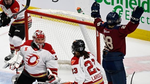 A hockey player celebrates a goal.