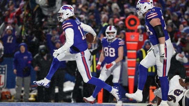 A football player scores a touchdown.