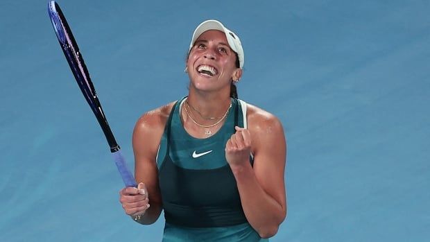 A womrn;s tennis player pumps her fists in celebration.