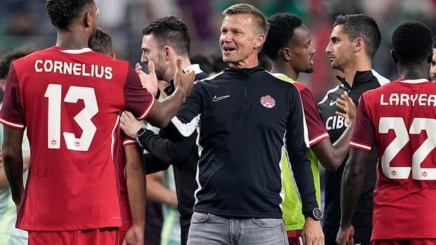 Canada men's soccer head coach Jesse Marsch talks with Derek Cornelius after the team's international friendly against Mexico in Arlington, Texas on September 10, 2024.