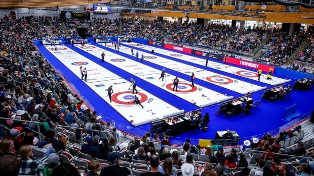 A curling rink is pictured from a high-level view.