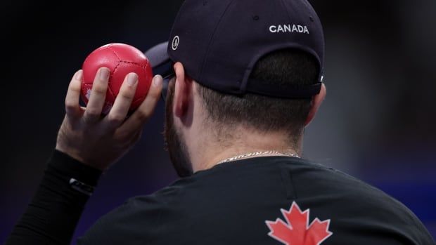 A boccia player prepares to throw the ball.