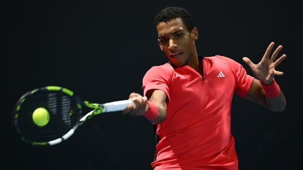 A male tennis player plays a forehand with the racket in his right hand.