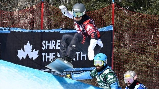 Canadian athlete Eliot Grondin of Sainte-Marie Que., followed by Lorenzo Sommarina, centre, and Nick Baumgartner race the Eight Finals in men's snowboard cross on March 24, 2024 at a World Cup event in Beaupre, Quebec.