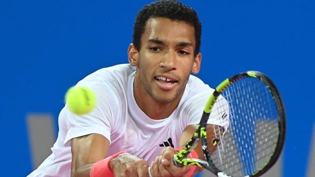 Canadian men's tennis player Felix Auger Aliassime stretches to return the ball to American Aleksandar Kovacevic during the final of the ATP World Tour Open Occitanie in Montpellier, France on February 2, 2025.