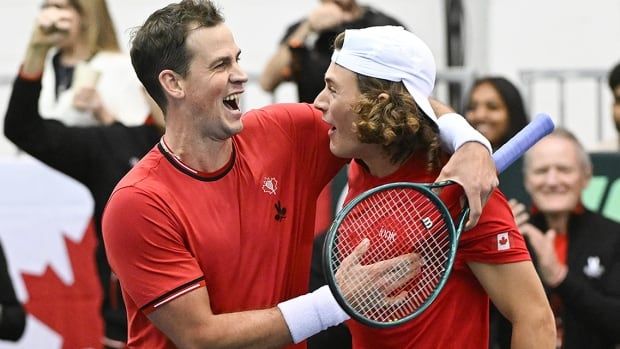 Vasek Pospisil and Liam Draxl share a laugh during their Davis Cup qualifying tennis match against Peter Fajta and Mate Valkusz of Hungary in Montreal on February 2, 2025. 