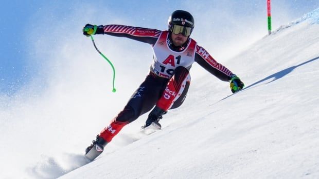 A men's skier is shown making a turn on the mountain.