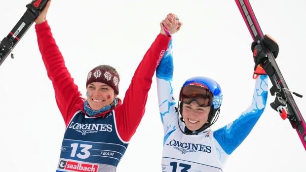 Two women skiers celebrate.