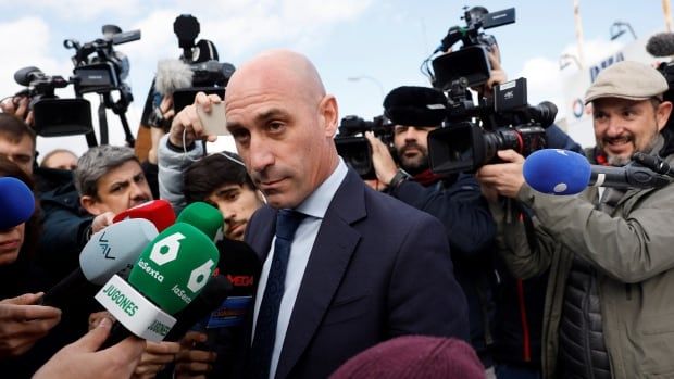 A man is interviewed during a media scrum after exiting court.