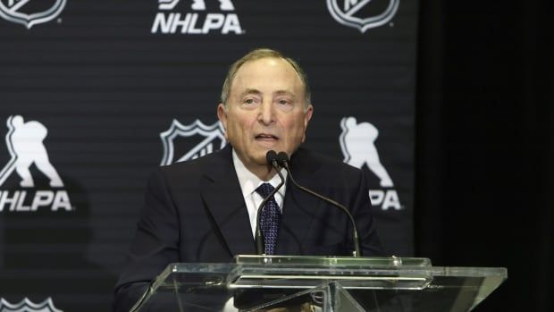 A male executive speaks at a podium.