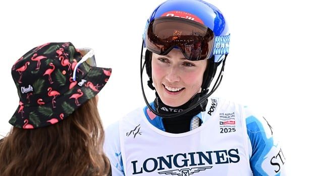 American alpine skier Mikaela Shiffrin is congratulated by teammate Lauren Macuga following a women's team combined event at the world championships February 11, 2025 in Saalbach-Hinterglemm, Austria. 