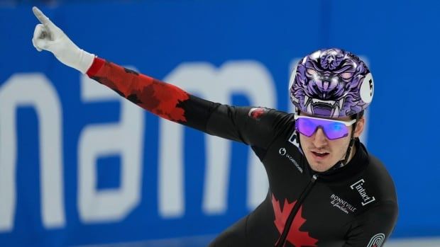 A speed skater celebrates a win.