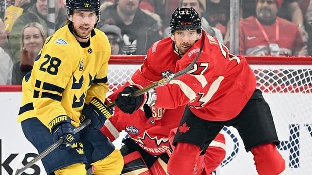 Canada defenceman Shea Theodore and Sweden forward Elias Lindholm battle for position in front of Canadian goalie Jordan Binnington during 4 Nations Face-Off action at Bell Centre in Montreal on February 12. 