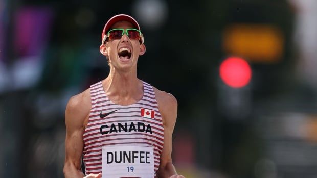 A men's racewalker celebrates.