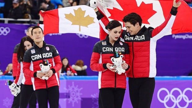 Canada's Scott Moir, Tessa Virtue and Patrick Chan celebrate their gold-medal victory in the team figure skating event at the Pyeonchang Olympics on February 12, 2018 in Gangneung, South Korea. 