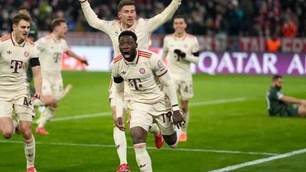 A male soccer player celebrates after scroing a goal.