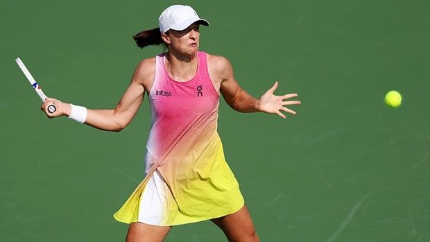 Polish tennis player Iga Swiatek plays a forehand against Mirra Andreeva of Russia in their quarterfinal at the Dubai Championships on February 20, 2025. 