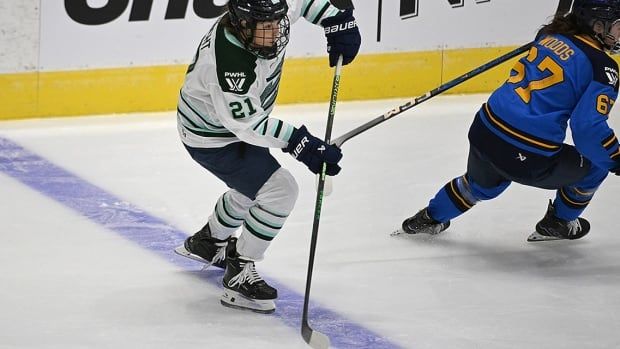 Boston Fleet forward Hilary Knight plays a pass behind Toronto Sceptres forward Emma Woods in the first period at Coca-Cola Coliseum in Toronto on November 30, 2024. 