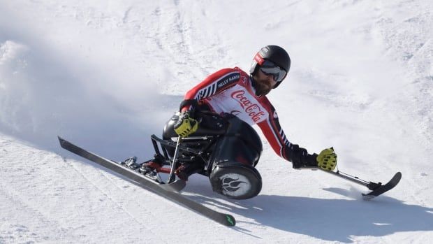 A men's sitting skier competes.