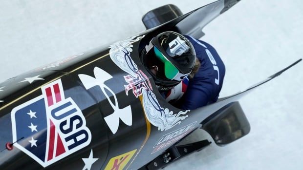 A female bobsledder speed down the track.